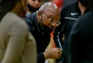 Peoria High head coach Demetrius Edwards talks with his players before the start of their game against Morton on Saturday, Jan.15, 2022 at Peoria High School. The Lions defeated the Potters 41-32.