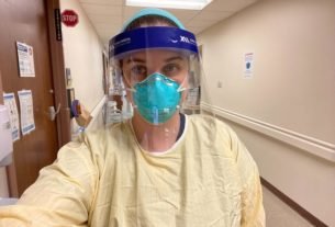 Melissa Schumacher, nurse manager of St. Elizabeth-Edgewood Pulmonary Unit, enters a COVID-19 patient's room on Thursday, Jan. 20, 2022. She works as a staff nurse as well as managing her staff because of nursing shortages - often caused by her staff getting COVID-19.