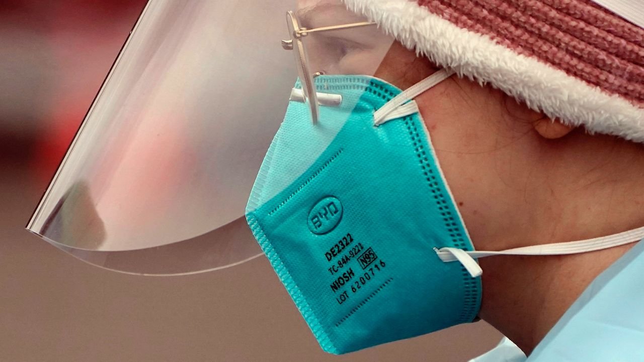 Linsey Jones, a medical assistant working at a drive-up COVID-19 testing clinic, wears an N95 mask, Tuesday, Jan. 4, 2022, in Puyallup, Wash., south of Seattle. (AP Photo/Ted S. Warren)