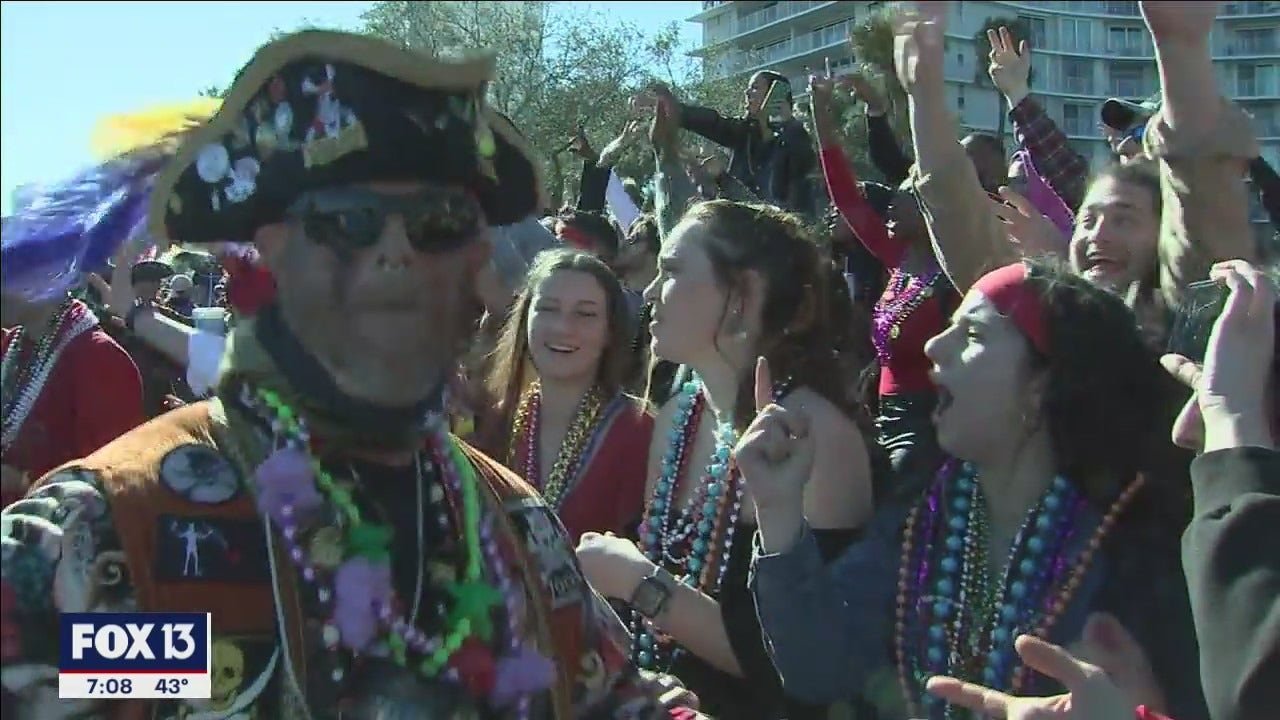 Pirates donned beads, boots, bundled layers, but few masks as they paraded down Bayshore